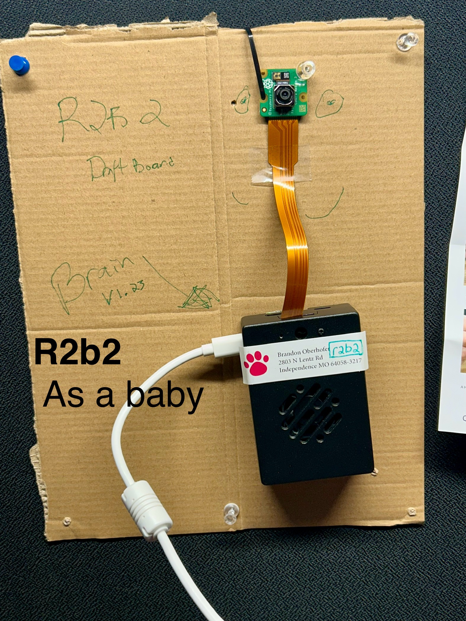 Early R2B2 prototype pinned to cubicle wall — Brain v1.23 draft board